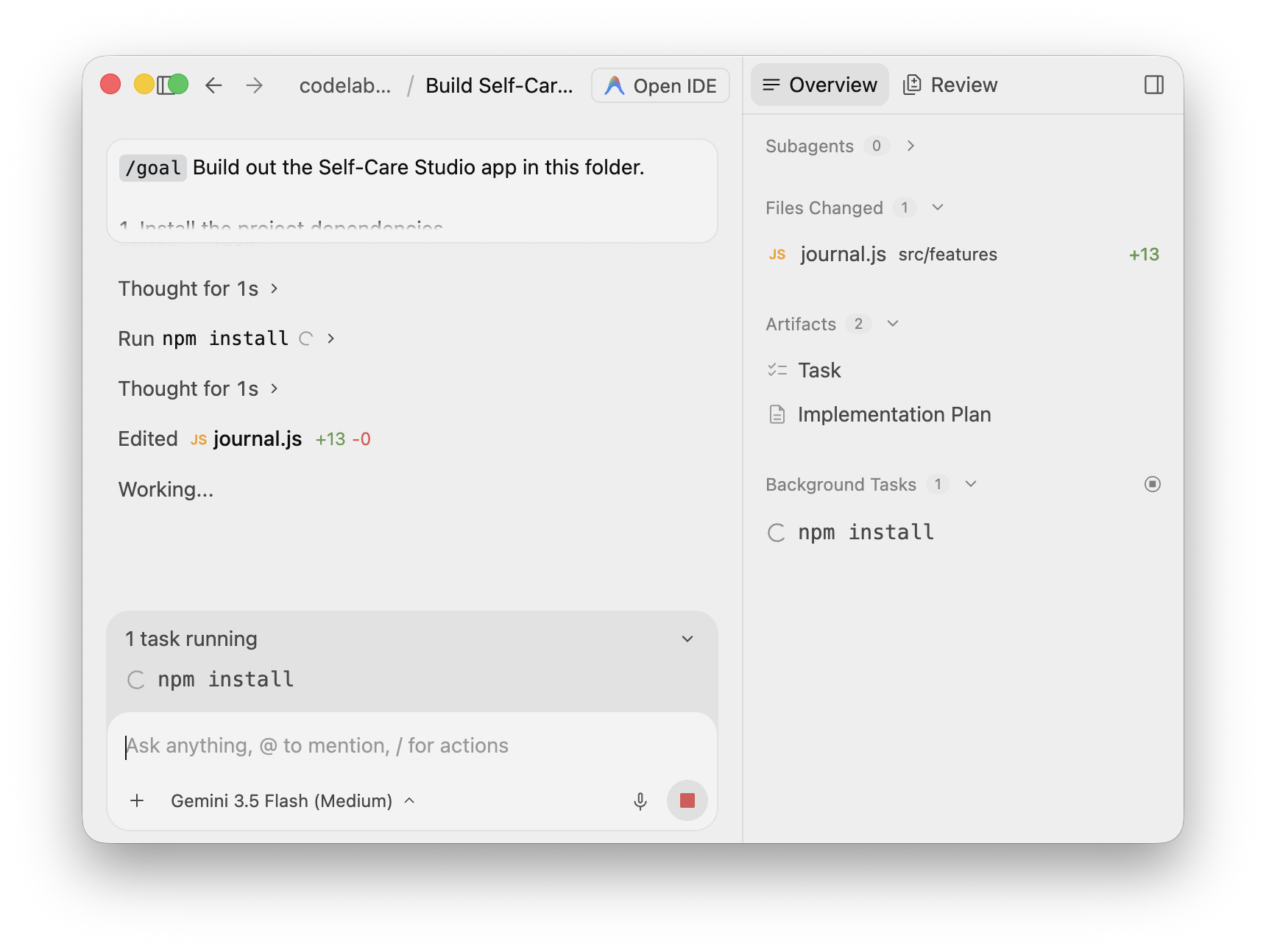 The agent edits journal.js while npm install is still running in the background; Overview shows Files Changed 1 and Background Tasks still lists npm install
